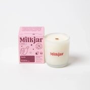 Milkjar Dandy scented coconut soy candle with pink packaging, mahogany firewood pine