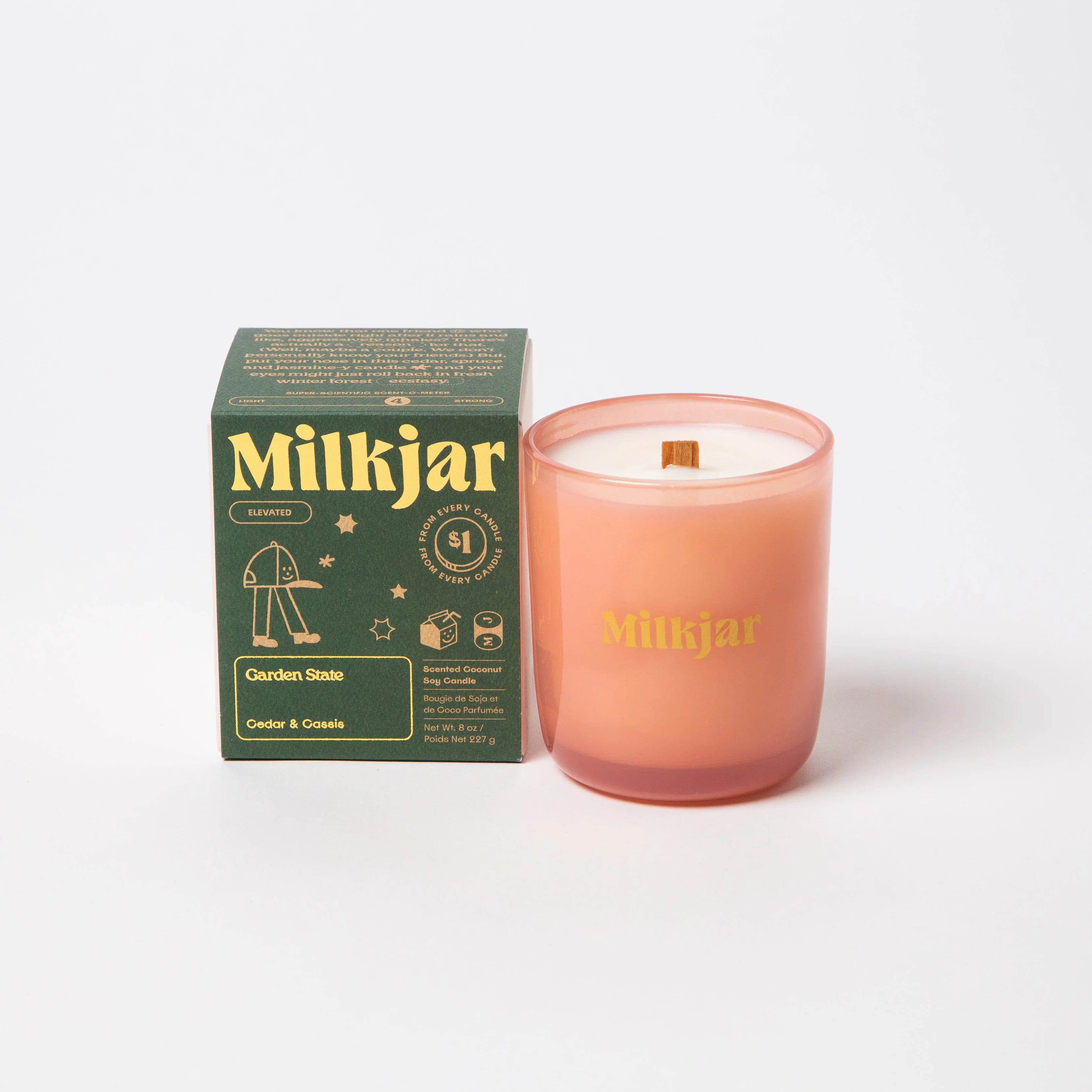 Milkjar Garden State cedar and cassis soy candle in pink glass with packaging