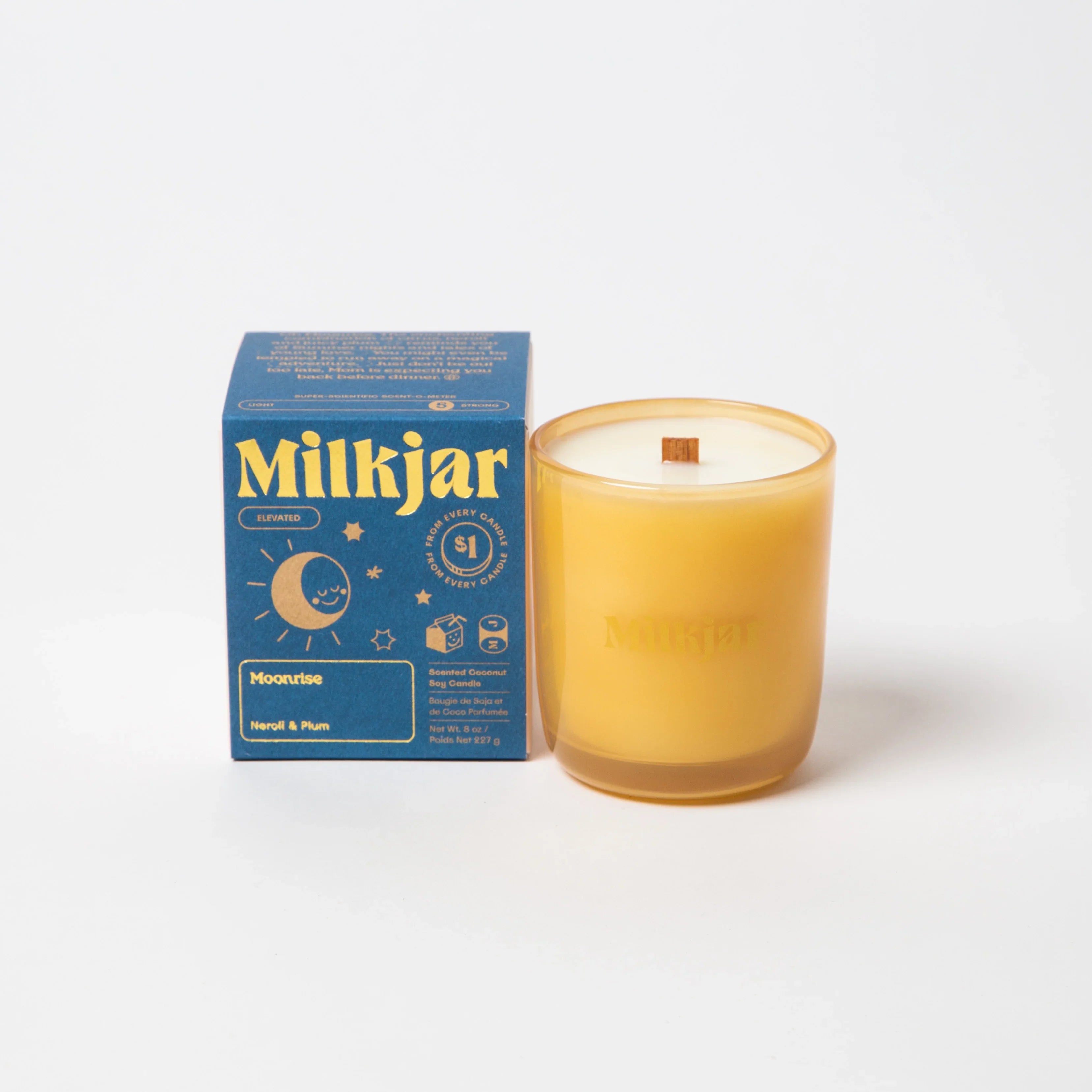 Milkjar Moonrise scented candle in yellow glass jar with blue box, neroli and plum scent