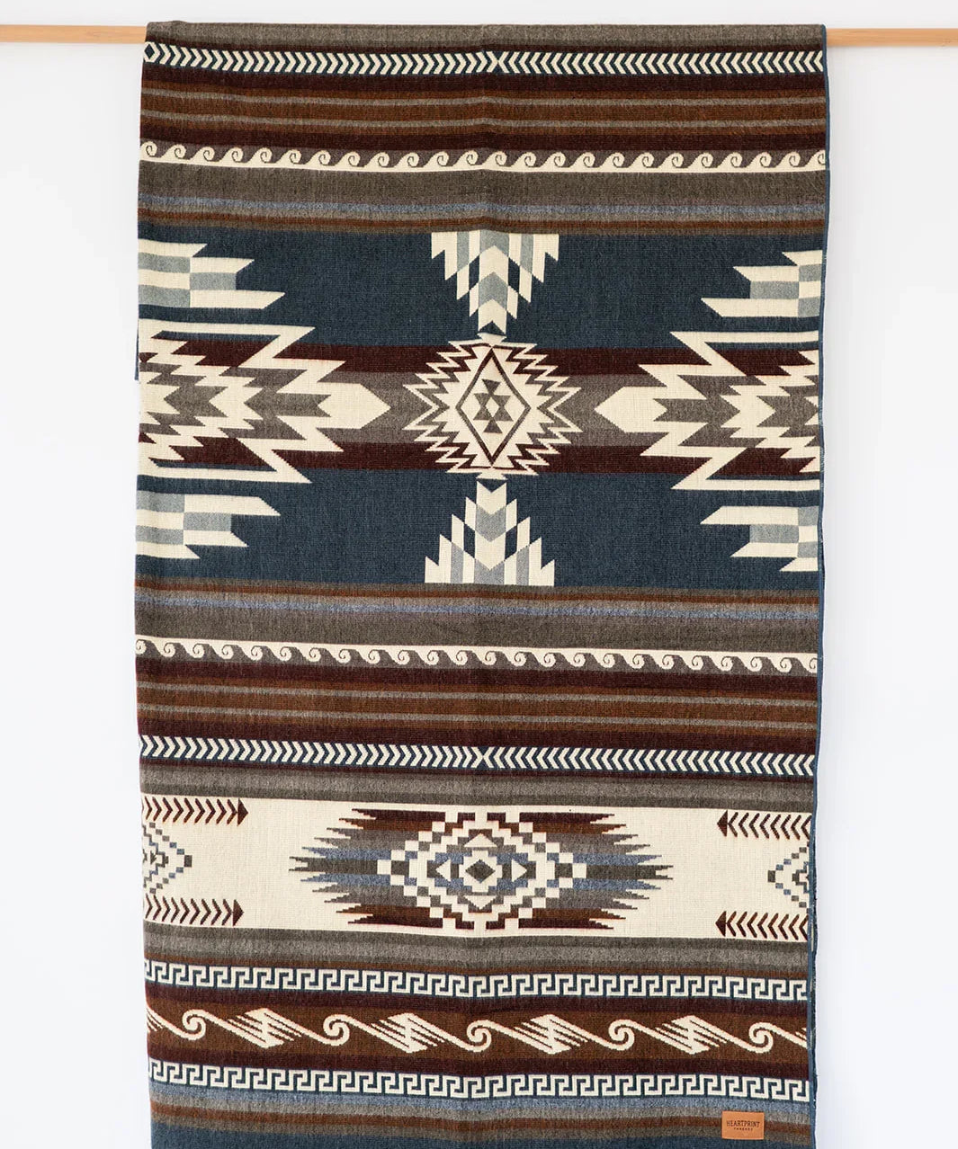 Woven Queen Blanket hanging on white background, country living