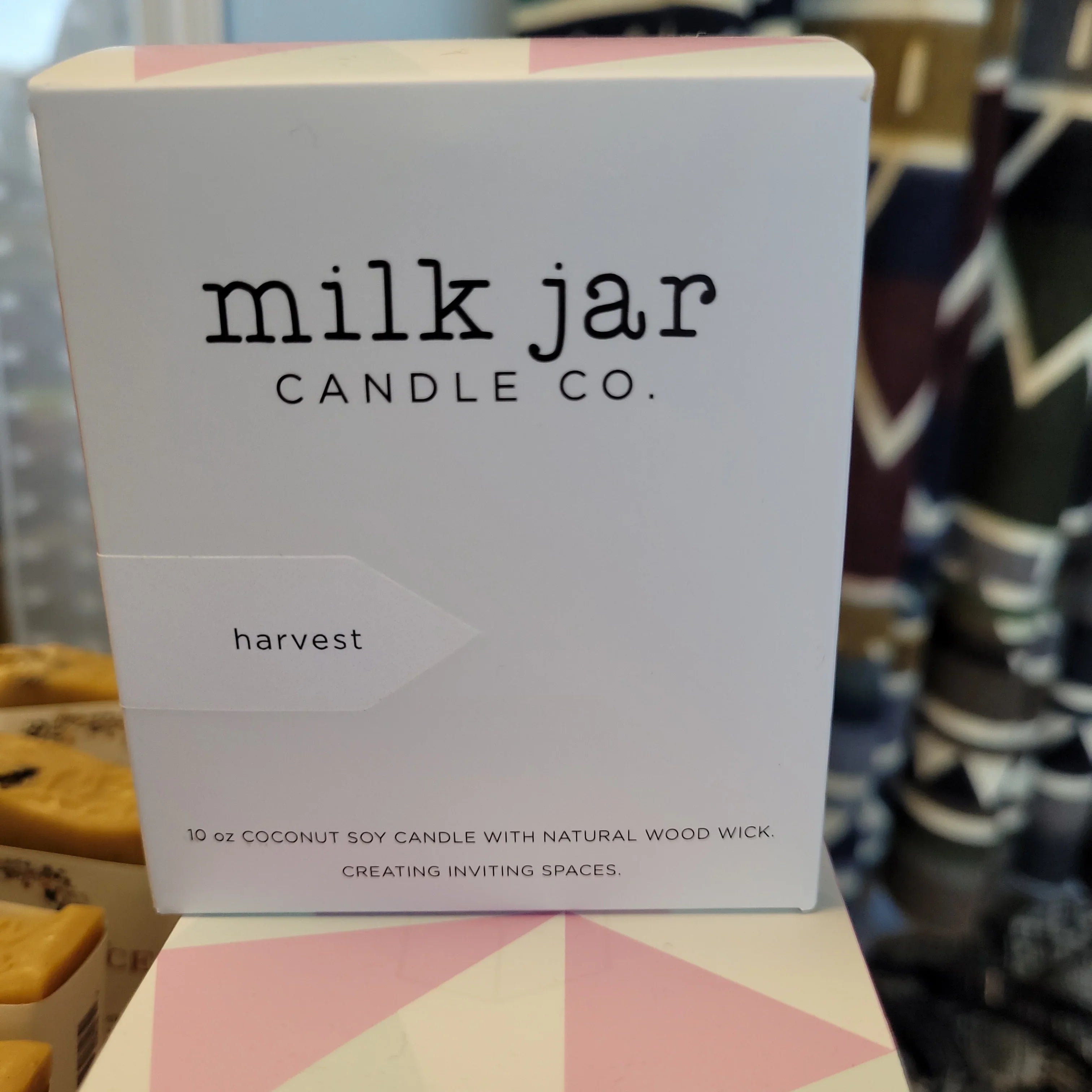 Milk Jar Coconut Soy Candle Harvest scent in white box with geometric background.