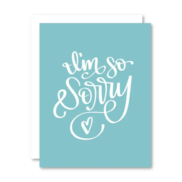 Blue greeting card with white hand-lettered text 'I'm so sorry' and a small heart.