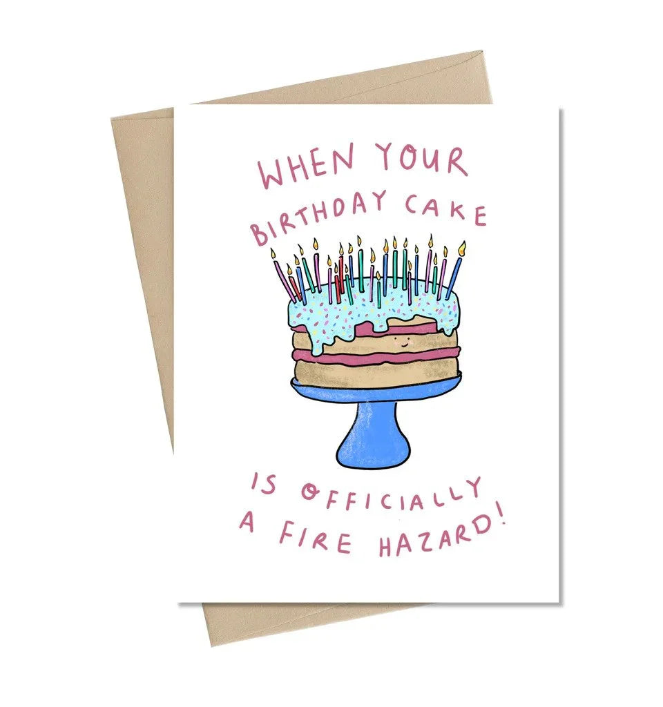 Funny birthday card with illustrated cake covered in candles and playful fire hazard message